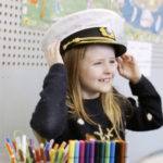 Girl wearing captain's hat