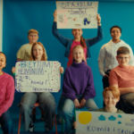 Group of Icelandic children hold up signs inviting volunteers