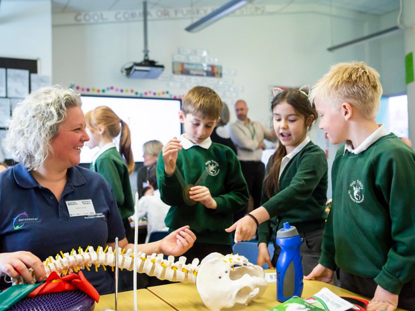 Photos of Inspiring the Future volunteers interacting with primary school ages children.