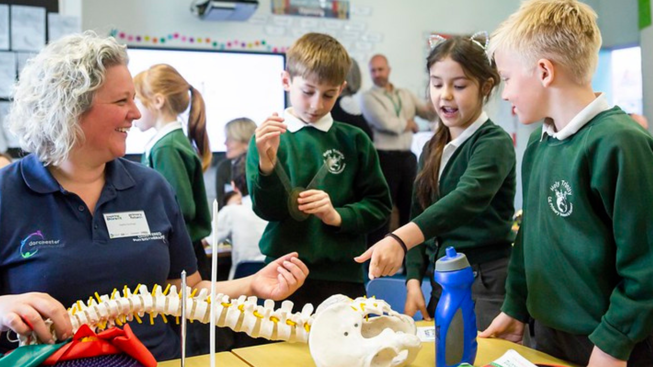 Photos of Inspiring the Future volunteers interacting with primary school ages children.